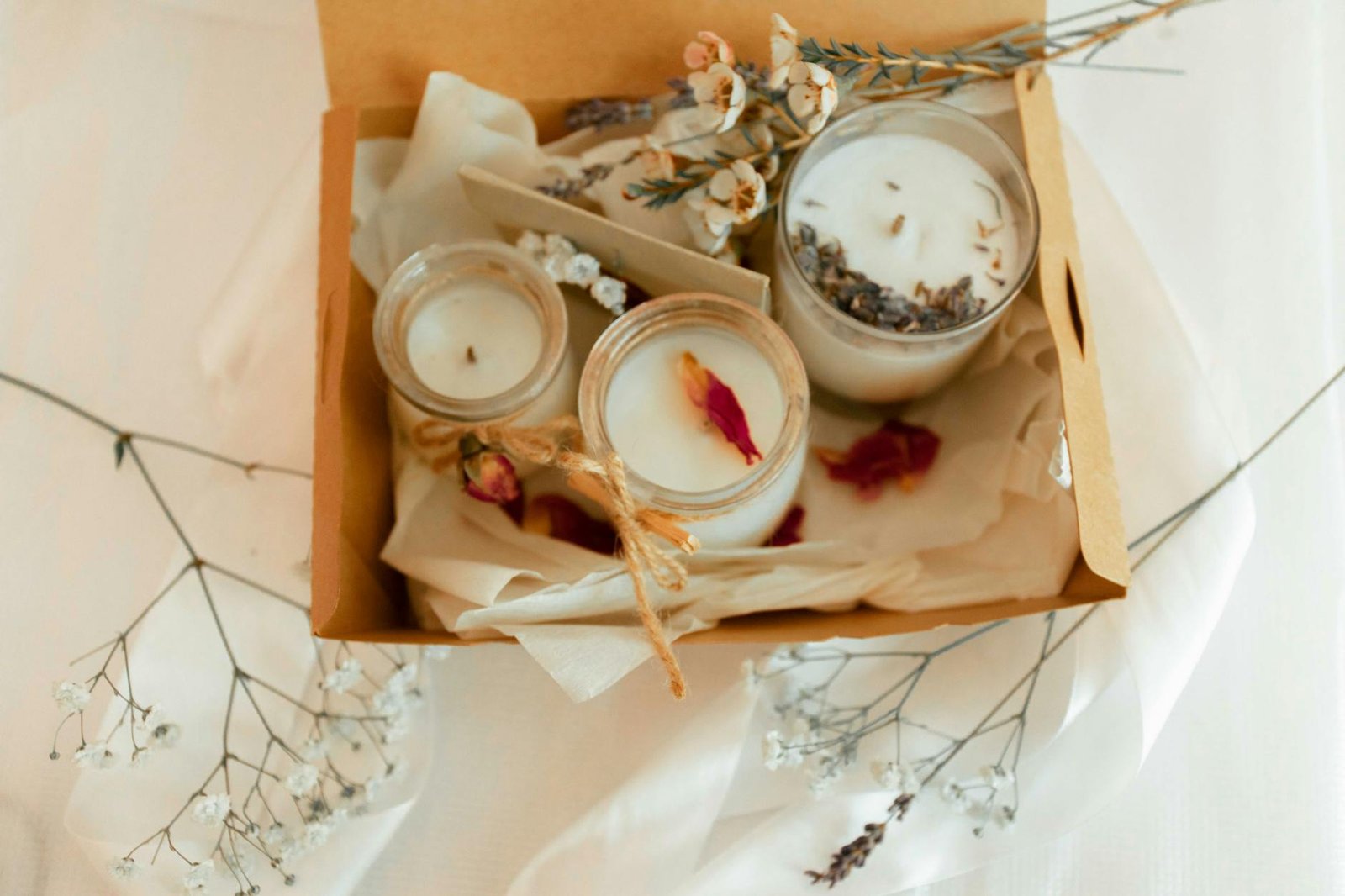 box with scented candles on fabric
